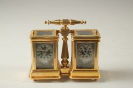 A SEVRES MODEL DOUBLE CARRIAGE CLOCK with porcelain panels and carrying handles. 10cms high.