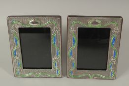 A PAIR OF SILVER AND ENAMEL PHOTOGRAPH FRAMES. 18 x 14cms.