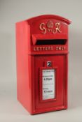 A RED CAST IRON POST BOX. 55cms high.