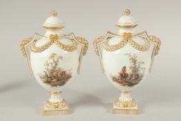 A PAIR OF MEISSEN LIDDED VASES painted with figures in pastoral landscapes. The body of the vases