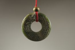 A CHINESE CARVED JADE LUCKY RING.