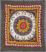 AN UZBEK SUZANI EMBROIDERED TEXTILE, with central floral motif in yellow, orange, green, purple, and