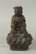 A 19TH CENTURY OR EARLIER CHINESE BRONZE SEATED BUDDHA UPON A LOTUS BASE, 26.5cm high.
