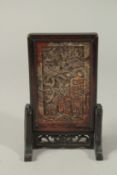 A CHINESE CARVED DRAGON SOAPSTONE MINIATURE SCREEN, inset within a hardwood frame with