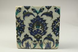 A 17TH CENTURY SYRIA DAMASCUS GLAZED POTTERY TILE, 23cm x 23cm.