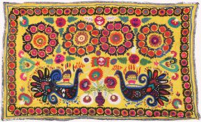 AN UZBEK SUZANI EMBROIDERED TEXTILE, with vibrant polychrome decoration of peacocks and blossoming