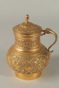 A TURKISH OTTOMAN GILDED COPPER JUG, 17cm high.