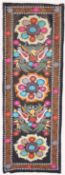 AN UZBEK SUZANI EMBROIDERED TEXTILE, with polychrome decorative floral roundels and birds, 228cm x