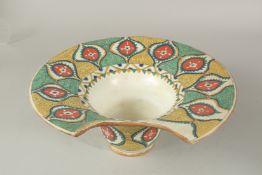A TURKISH OTTOMAN IZNIK DESIGN POTTERY BARBER'S WASH BASIN, 31cm wide.
