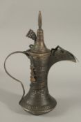 A FINE AND LARGE ARAB OMANI IT EMARATI COFFEE POT DALLAH, 39cm high.