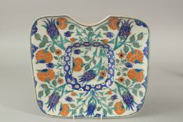 A TURKISH OTTOMAN IZNIK DESIGN BARBER'S WASH TRAY, 31cm x 28.5cm.