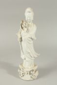A BLANC-DE-CHINE PORCELAIN FIGURE OF GUANYIN STOOD UPON A LILYPAD, with fine floral details to the