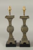 A PAIR OF 19TH CENTURY GU-FORM PEWTER VASES CONVERTED TO LAMPS, 42.5cm high overall.
