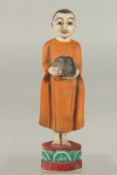A FOLK ART PAINTED CARVED WOOD FIGURE, 27cm high.