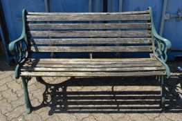A cast iron and wooden slatted garden bench.
