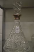 Cut glass decanter with silver collar.
