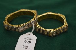 A good piar of gold bangles inset with diamonds.