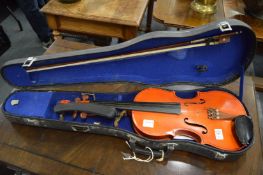 A cased violin and bow.