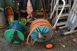 A Gardena garden hose reel and another hose reel.