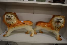 A pair of large Staffordshire pottery lions.