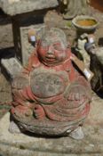 A reconstituted stone garden ornament modelled as Buddha.