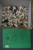 A collection of excavated clay pipes together with a clay pipe book.