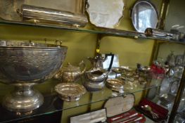 A large plated punch bowl, engraved teapot, tinted glass condiment set with plated stand and other