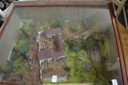A military diorama in display case.