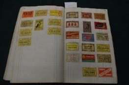 An old cashbook containing numerous matchbox covers.
