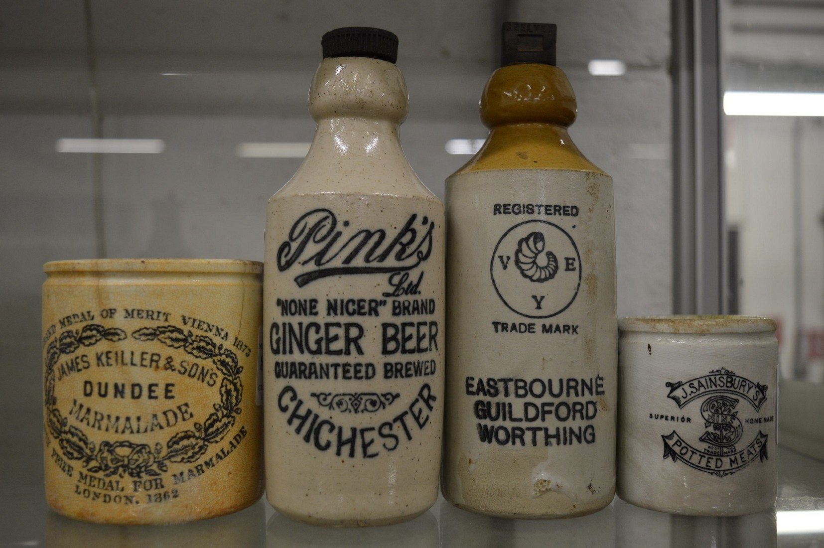 A Pinks ginger beer bottle, a Shelvey & Co Ltd ginger beer bottle and two other items.