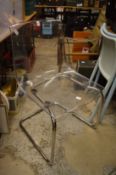 A stylish perspex and chrome dining chair.