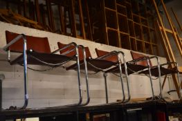 A set of four chrome framed cantilever dining chairs.