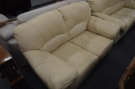 Modern cream leather upholstered two seater settee.