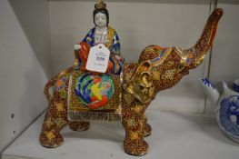 Colourful Satsuma group depicting a female figure seated on an elephant.