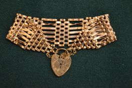 A 9ct gold curb link bracelet with padlock clasp.