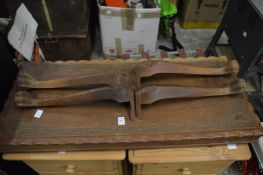 A hardwood table and two wine racks.
