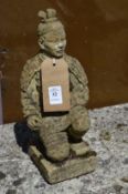 A small reconstituted stone garden ornament modelled as a seated Chinese warrior.
