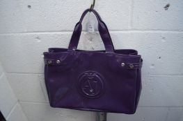 An Armani purple handbag and another handbag.