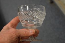 A part suite of Webb cut glass drinking glasses together with a set of twelve cut glass wine
