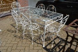 A wrought iron and white painted glass top rectangular dining table with a set of six wrought iron