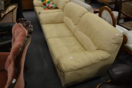 Modern cream leather upholstered two seater settee.