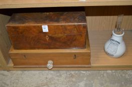 Two wooden boxes and an inhaler.