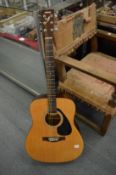 A Yamaha F310 classical guitar with case.