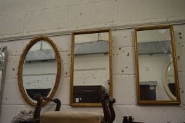 Three small gilt mirrors.