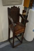 A 17th century style carved oak child's high chair.