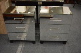 A pair of mirrored three drawer bedside chests.
