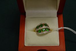 A 14ct yellow gold, diamond and green stone dress ring.