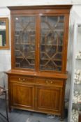 An Edwardian inlaid mahogany cupboard bookcase.