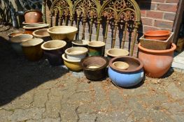 A large quantity of terracotta and earthenware plant pots.