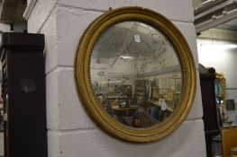 A gilt framed convex mirror.